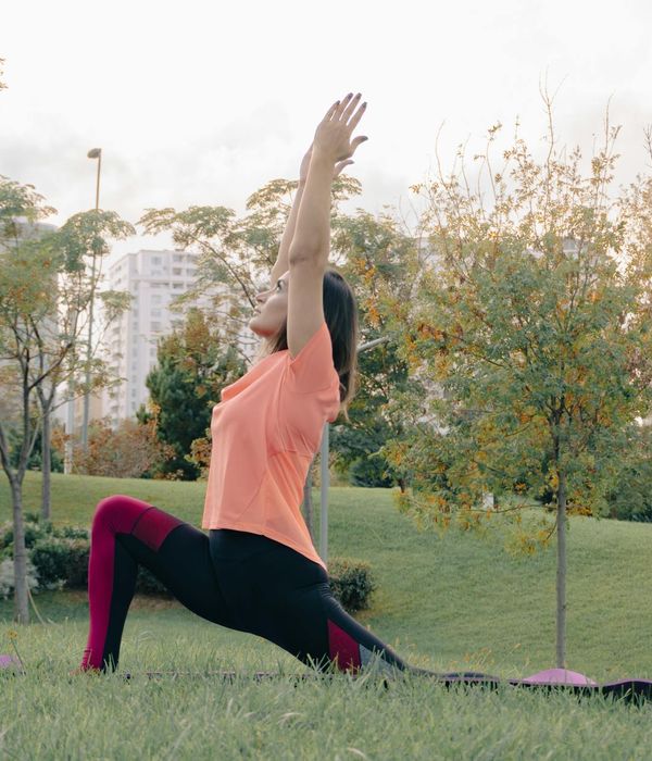 Woman performing a graceful yoga pose, embodying balance and flexibility.